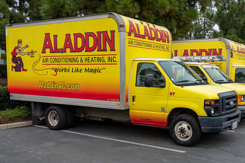 Aladdin HVAC trucks sitting in parking lot.